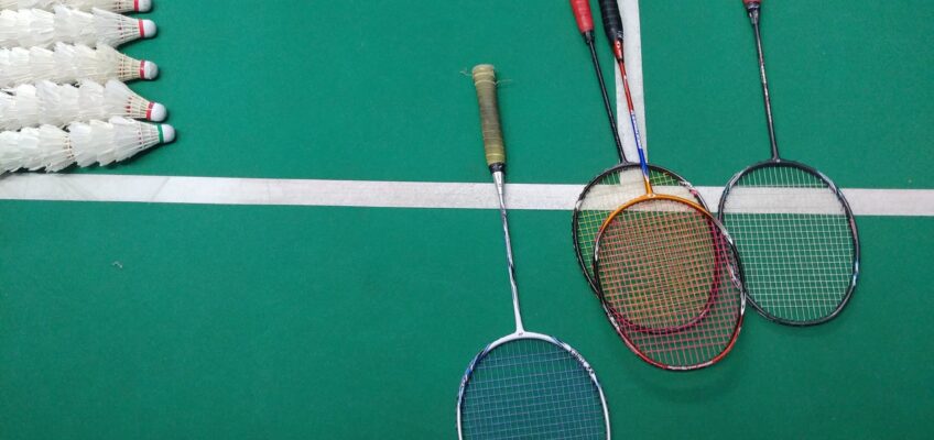 Green and White Court with Badminton Rackets